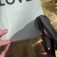 Embosser tool creating a cozy cat-themed bookplate for home library